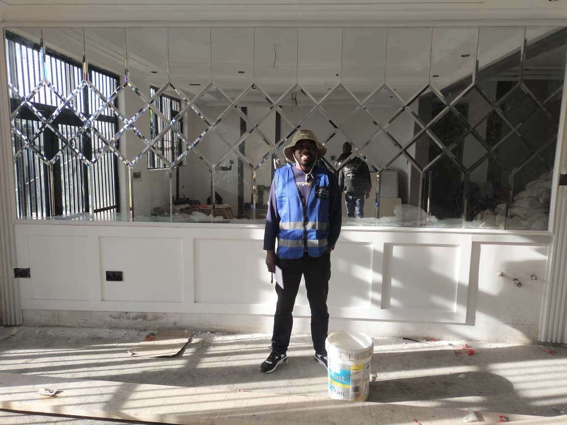 Mirrored feature wall and decorative moulding installation in progress